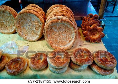 Stock Photography - Stack of flat bread and toppings at outdoor food market at XiÂ´an LianHu Historical & Cultural Blocks.. Fotosearch