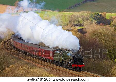 Stock Photography - Steam train 46115 Scots Guardsman on the Settle to Carlisle Railway Line near Low Baron Wood Farm Armathwaite Eden Valley Cumbria England United Kingdom Great Britain.. Fotosearch