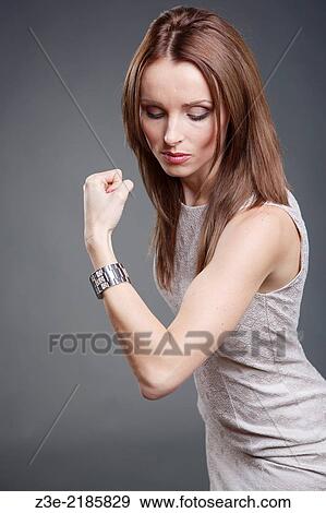 Studio portrait of a female office worker with strong biceps. View Large Photo Image Stock Photo - Studio portrait of a female office worker with strong biceps.. Fotosearch