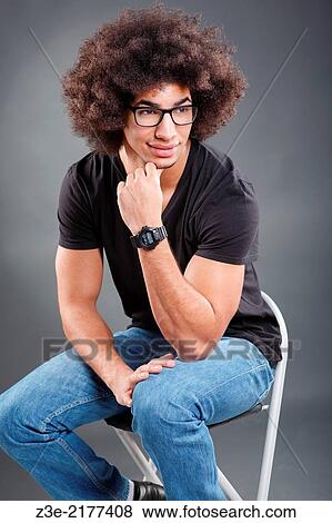 studio portrait of young man in front of gray background. View Large Photo Image Stock Photo - studio portrait of young man in front of gray background.. Fotosearch