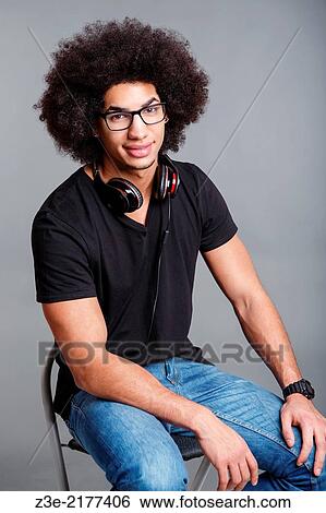 studio portrait of young man in front of gray background. View Large Photo Image Stock Photograph - studio portrait of young man in front of gray background.. Fotosearch