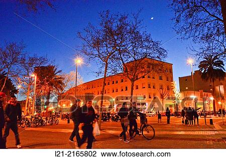 Stock Image - Sunset, night. Passeig Joan de BorbÃ³, Barceloneta, Barcelona, Catalonia, Spain.. Fotosearch