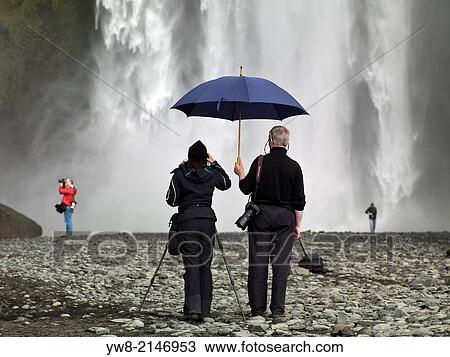 Taking pictures at Skogafoss Waterfalls, Iceland View Large Photo Image Stock Image - Taking pictures at Skogafoss Waterfalls, Iceland. Fotosearch