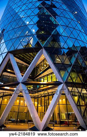 Stock Photo - The Gherkin Swiss Re Tower at night, City of London, England, UK.. Fotosearch
