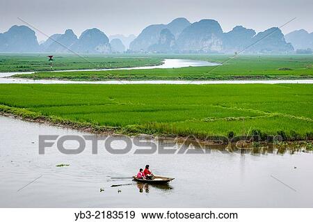 Stock Photo - The Ngo Dong River and Mountain Scenery, Tam Coc, Ninh Binh Province, Vietnam.. Fotosearch