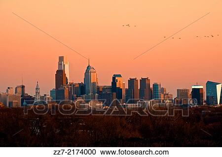 Stock Image - The sun sets across the Philadelphia skyline.. Fotosearch