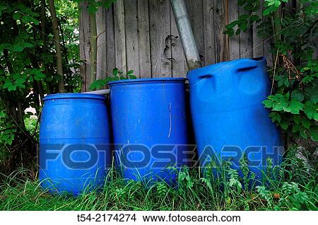 Three blue rainwater collection barrels View Large Photo Image Picture - Three blue rainwater collection barrels. Fotosearch