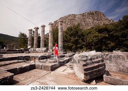 Tourist at the Temple of Athena, the ancient city of Priene, Soke, Aydin, Turkey, Europe. View Large Photo Image Picture - Tourist at the Temple of Athena, the ancient city of Priene, Soke, Aydin, Turkey, Europe.. Fotosearch