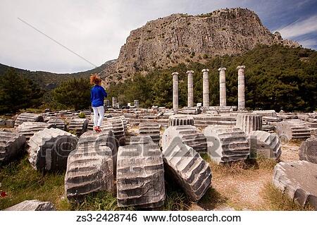 Tourist at the Temple of Athena, the ancient city of Priene, Soke, Aydin, Turkey, Europe. View Large Photo Image Stock Photograph - Tourist at the Temple of Athena, the ancient city of Priene, Soke, Aydin, Turkey, Europe.. Fotosearch