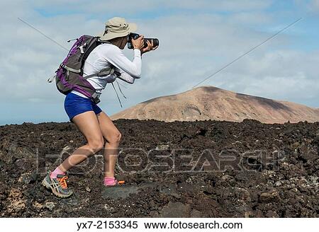 Tourist taking photos at Timanfaya National Park, Lanzarote, Canary Islands, Spain. View Large Photo Image Stock Photography - Tourist taking photos at Timanfaya National Park, Lanzarote, Canary Islands, Spain.. Fotosearch