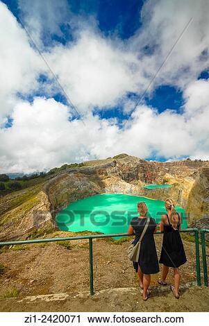 tourists at colourful volcanic lake of kelimutu volcano at flores indonesia View Large Photo Image Stock Image - tourists at colourful volcanic lake of kelimutu volcano at flores indonesia. Fotosearch