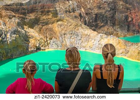 tourists at colourful volcanic lake of kelimutu volcano at flores indonesia View Large Photo Image Stock Image - tourists at colourful volcanic lake of kelimutu volcano at flores indonesia. Fotosearch