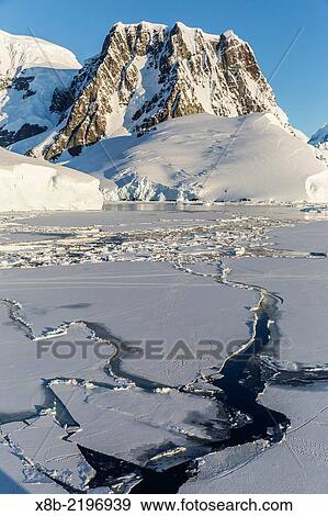 Transiting the Lemaire Channel in heavy first year sea ice, Antarctica. View Large Photo Image Stock Photo - Transiting the Lemaire Channel in heavy first year sea ice, Antarctica.. Fotosearch