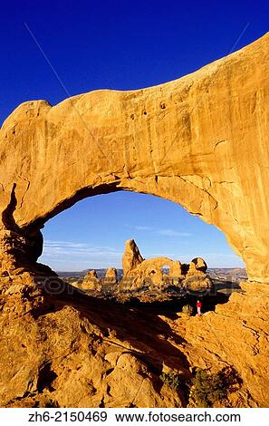 Turret Arch through North Window (hiker visible), Arches National Park, Utah USA. View Large Photo Image Stock Photo - Turret Arch through North Window (hiker visible), Arches National Park, Utah USA.. Fotosearch