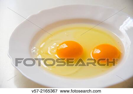 Two yolks in a dish. Close view. View Large Photo Image Stock Photo - Two yolks in a dish. Close view.. Fotosearch