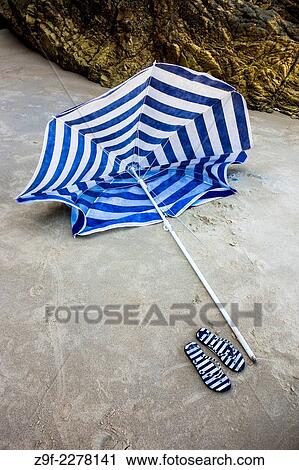 Umbrella with sandals on the beach of La Franca, Asturias, Spain View Large Photo Image Stock Image - Umbrella with sandals on the beach of La Franca, Asturias, Spain. Fotosearch