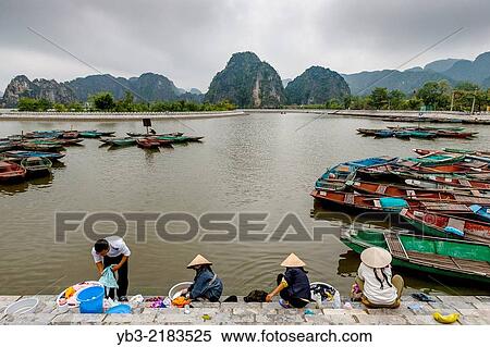 Vietnamese People Washing Clothes In The Ngo Dong River, Tam Coc, Ninh Binh Province, Vietnam. View Large Photo Image Stock Photography - Vietnamese People Washing Clothes In The Ngo Dong River, Tam Coc, Ninh Binh Province, Vietnam.. Fotosearch