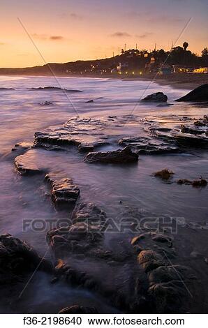Waves on coastal rocks at sunset, Crystal Cove State Park Historic District beach, Corona del Mar, Newport Beach, California. View Large Photo Image Stock Image - Waves on coastal rocks at sunset, Crystal Cove State Park Historic District beach, Corona del Mar, Newport Beach, California.. Fotosearch
