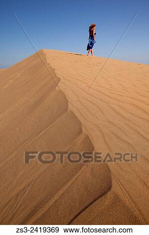 Woman at the sand dunes of Maspalomas, Gran Canaria, Canary Islands, Spain, Europe. View Large Photo Image Stock Photo - Woman at the sand dunes of Maspalomas, Gran Canaria, Canary Islands, Spain, Europe.. Fotosearch