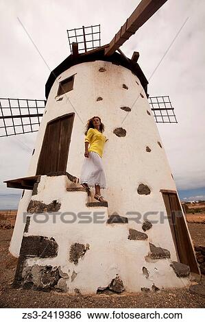 Woman at the stairs of the windmill in El Roque near El Cotillo, Fuerteventura, Canary Islands, Spain, Europe. View Large Photo Image Stock Photograph - Woman at the stairs of the windmill in El Roque near El Cotillo, Fuerteventura, Canary Islands, Spain, Europe.. Fotosearch