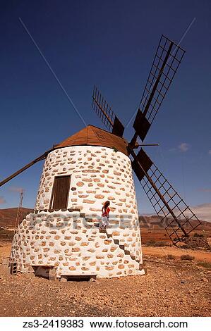Woman at the stairs of the windmill near Tefia, La Oliva, Fuerteventura, Canary Islands, Spain, Europe. View Large Photo Image Stock Image - Woman at the stairs of the windmill near Tefia, La Oliva, Fuerteventura, Canary Islands, Spain, Europe.. Fotosearch