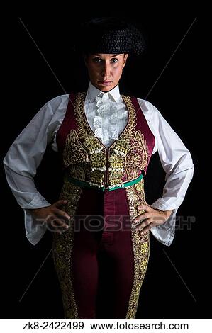 Woman bullfighter by dressing in a costume of old lighting on a black background. View Large Photo Image Stock Photo - Woman bullfighter by dressing in a costume of old lighting on a black background.. Fotosearch