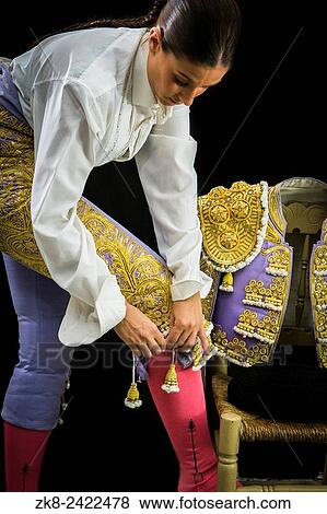Woman bullfighter by dressing with vest on your back on a black background. View Large Photo Image Stock Photo - Woman bullfighter by dressing with vest on your back on a black background.. Fotosearch