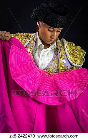 Woman bullfighter holding capote pink on black background. View Large Photo Image Stock Photo - Woman bullfighter holding capote pink on black background.. Fotosearch