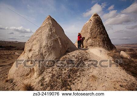 Woman near the fairy chimneys in Cavusin, Cappadocia Region, Nevsehir, Central Anatolia, Turkey, Europe. View Large Photo Image Stock Photograph - Woman near the fairy chimneys in Cavusin, Cappadocia Region, Nevsehir, Central Anatolia, Turkey, Europe.. Fotosearch