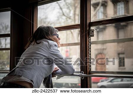 Woman traveling and looking out on a Tram window in Milan, Italy. View Large Photo Image Stock Photo - Woman traveling and looking out on a Tram window in Milan, Italy.. Fotosearch