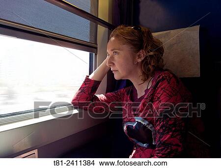 Picture - woman traveling by train, Barcelona. Fotosearch
