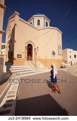 Woman with white headscarf in front of a colorful church in Hora, Serifos, Cyclades Islands, Greek Islands, Greece, Europe. View Large Photo Image Picture - Woman with white headscarf in front of a colorful church in Hora, Serifos, Cyclades Islands, Greek Islands, Greece, Europe.. Fotosearch