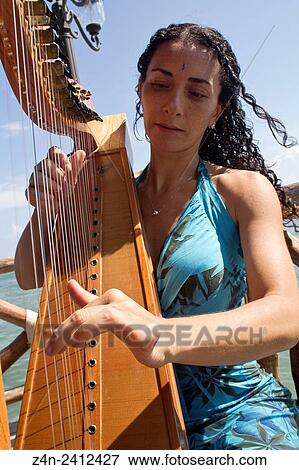 Stock Photo - Women playing harp, Caribean Sea.. Fotosearch