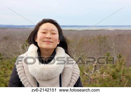 Young Asian woman enjoys the fresh spring air on Long Island, NY, USA. View Large Photo Image Stock Image - Young Asian woman enjoys the fresh spring air on Long Island, NY, USA.. Fotosearch