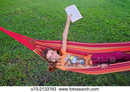 Young beautiful girl with book outdoor View Large Photo Image Stock Image - Young beautiful girl with book outdoor. Fotosearch