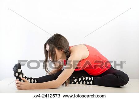 Stock Image - Young Woman doing Fitness in her home.. Fotosearch