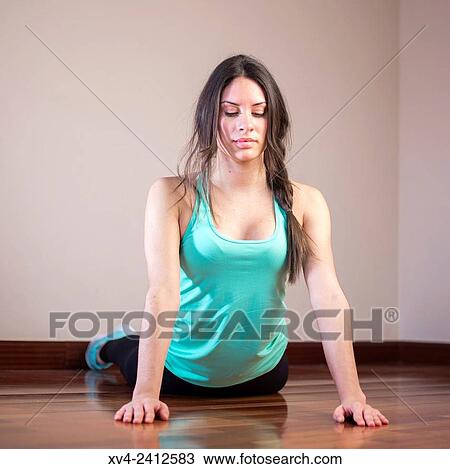 Stock Image - Young Woman doing Fitness in her home.. Fotosearch