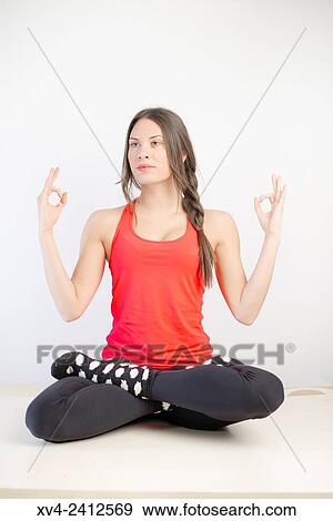 Stock Photo - Young Woman doing Fitness in her home.. Fotosearch