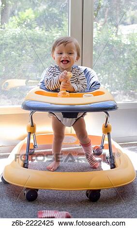 10 months old baby with a walker. View Large Photo Image Stock Photography - 10 months old baby with a walker.. Fotosearch