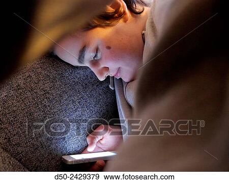 14 year old hanging upside down with iPhone on couch. Stockholm, Sweden View Large Photo Image Stock Photo - 14 year old hanging upside down with iPhone on couch. Stockholm, Sweden. Fotosearch