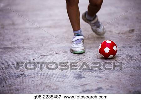 a boy shooting a ball View Large Photo Image Stock Photo - a boy shooting a ball. Fotosearch