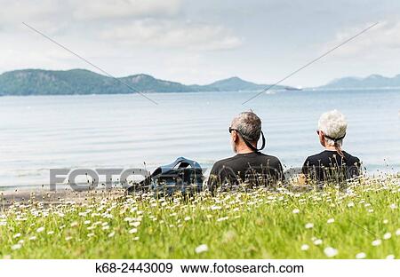 A senior couple sits on the beach on Saturna Island, Gulf Islands, British Columbia, Canada. View Large Photo Image Stock Photo - A senior couple sits on the beach on Saturna Island, Gulf Islands, British Columbia, Canada.. Fotosearch