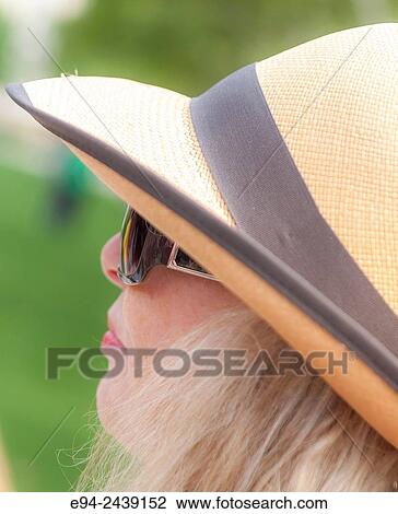 A tight profile of a 60 year old blond woman in Pittsburg, wearing a straw hat and sunglasses. View Large Photo Image Stock Image - A tight profile of a 60 year old blond woman in Pittsburg, wearing a straw hat and sunglasses.. Fotosearch