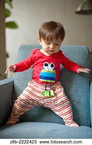 Almost 9 months old baby trying to stand up. View Large Photo Image Stock Image - Almost 9 months old baby trying to stand up.. Fotosearch
