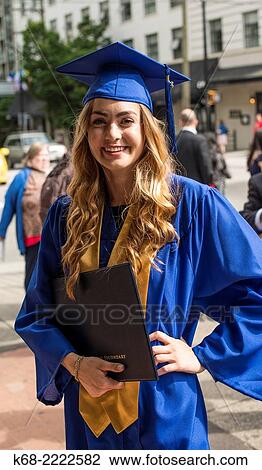 Stock Image - an 18 year old girl in her cap and gown for her graduation from high school, Vancouver, BC, Canada.. Fotosearch