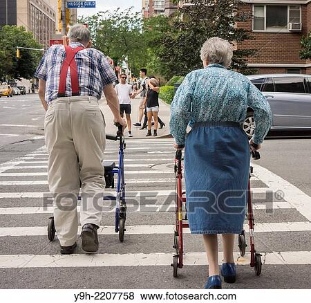 An elderly couple waits to crosses the street in the New York neighborhood of Chelsea View Large Photo Image Stock Photo - An elderly couple waits to crosses the street in the New York neighborhood of Chelsea. Fotosearch