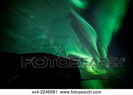 Stock Image - Aurora Borealis or northern Lights during winter at southern Iceland.. Fotosearch