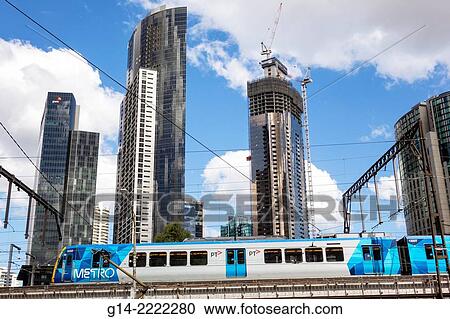 Stock Image - Australia, Victoria, Melbourne, Central Business District, CBD, Flinders Street, Metro Trains Rail Network, train, public transportation, Southbank high rise buildings, skyscrapers, city skyline, under, construction,.. Fotosearch