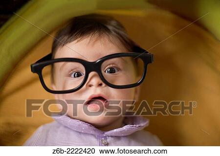 Baby girl, 6 months, head & shoulders, glasses, looking at camera, indoors. View Large Photo Image Stock Image - Baby girl, 6 months, head & shoulders, glasses, looking at camera, indoors.. Fotosearch