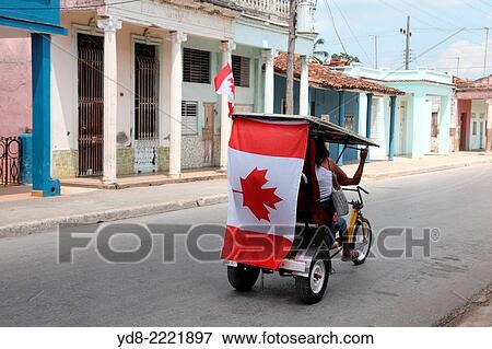 Bicitaxi with flag of Canada in Moron, Ciego de Avila, Cuba View Large Photo Image Stock Photo - Bicitaxi with flag of Canada in Moron, Ciego de Avila, Cuba. Fotosearch